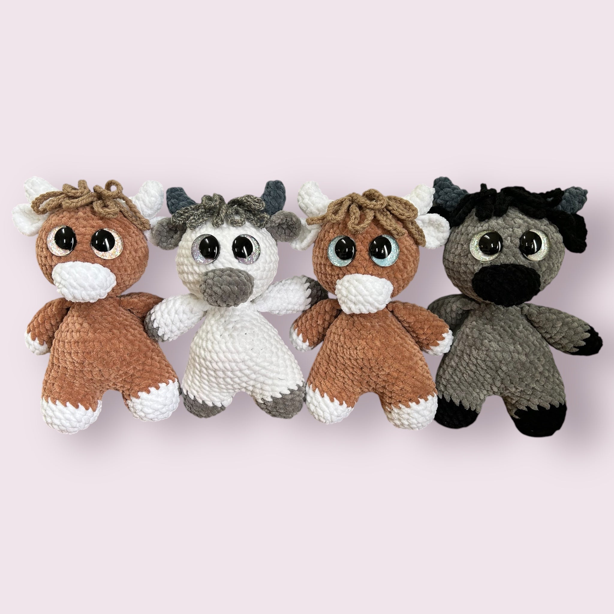 Hand crocheted Highland Cow Plushies in a variety of colors
